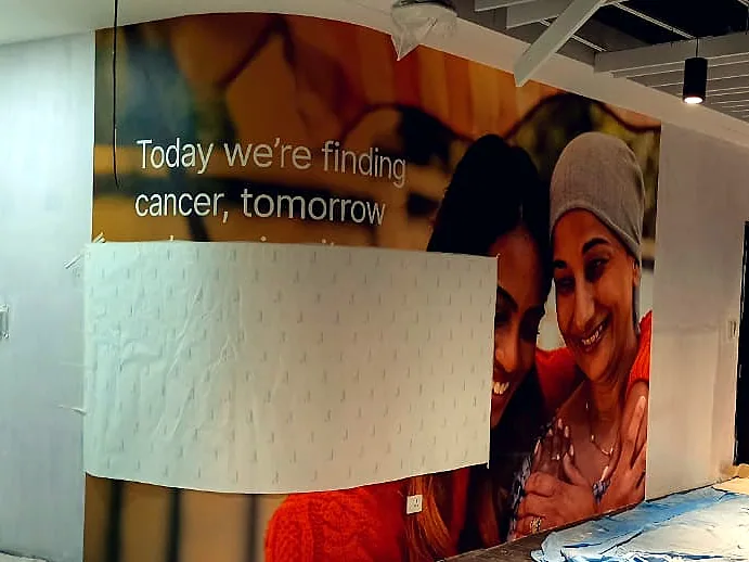 Printed wall graphic partly applied during installation