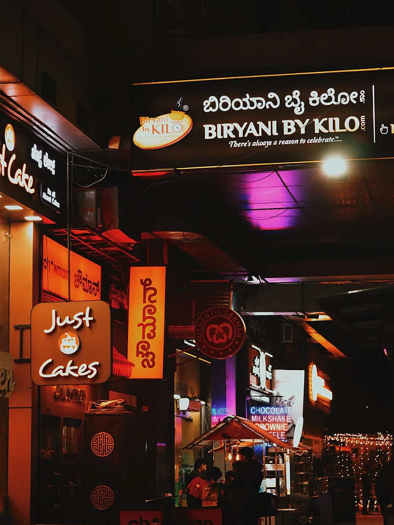 Shop-front lettering and signs lit at night