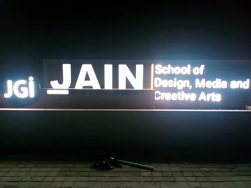 Illuminated institutional sign at night (Exterior Logo Signage)