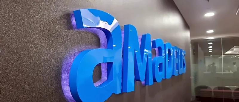 Glossy blue 3D logo letters on a wall