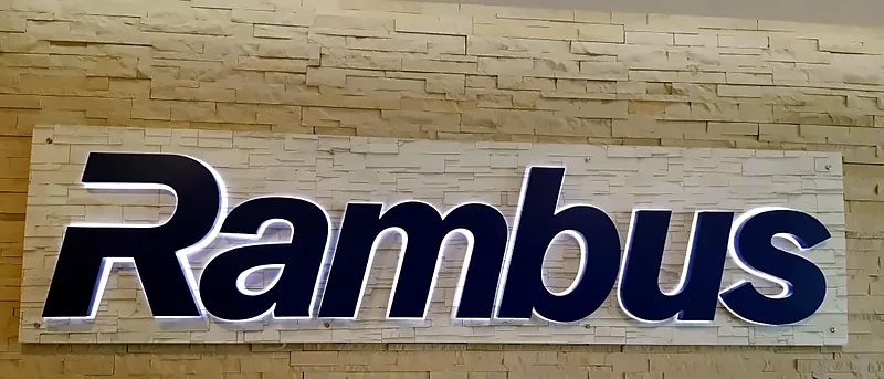 Flat halo-lit logo letters on stone cladding