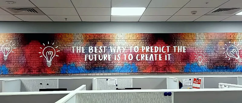 Printed statement banner running along an office wall
