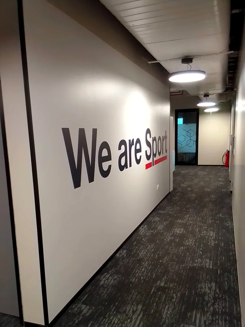 Bold wall graphic along a corridor: Environmental Graphics