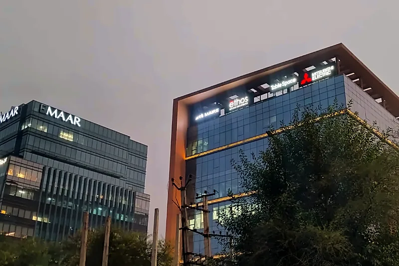 Glass office towers with rooftop logo signs
